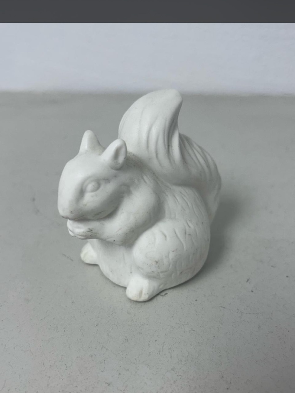 White Ceramic Squirrel Figurine light